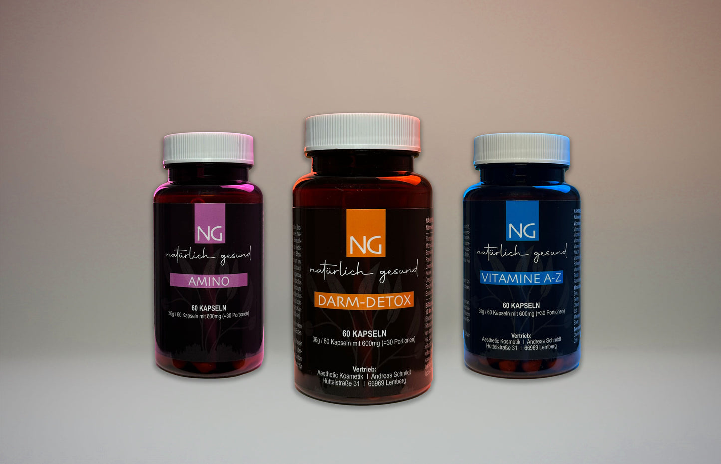 Drei Produktdosen, im Vordergrund das Darm-Detox mit der Farbe orange, links im Bild Amina mit der Farbe lila und auf der rechten Seite steht das Vitamin A-Z in der Farbe blau